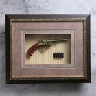 Souvenir item in a gilded frame, a pistol and cartridges in a gilded frame Souvenir item in a gilded frame, a pistol and cartridges in a gilded frame